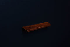 Top corner perspective of an American walnut wood handle showing natural grain and rounded edge