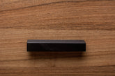 Black classic handle installed on walnut cabinet, perfect for traditional and modern interiors.