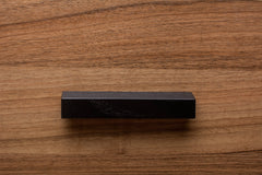 Black classic handle installed on walnut cabinet, perfect for traditional and modern interiors.