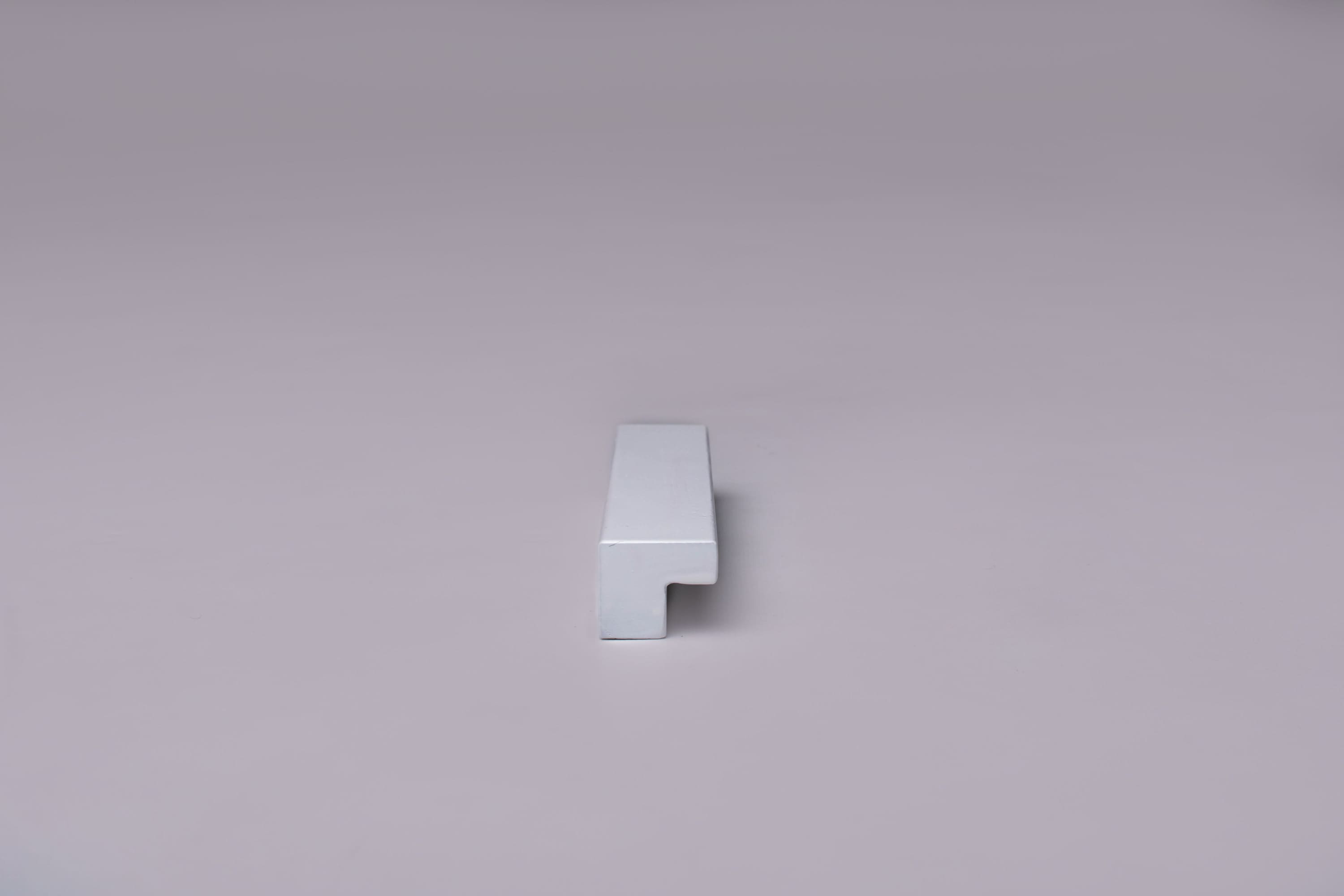 Classic L-Form White Cabinet Handle on gray