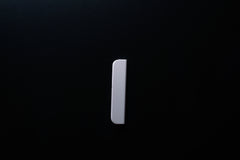White Wooden drawer  handle in vertical position with detailed view on grip