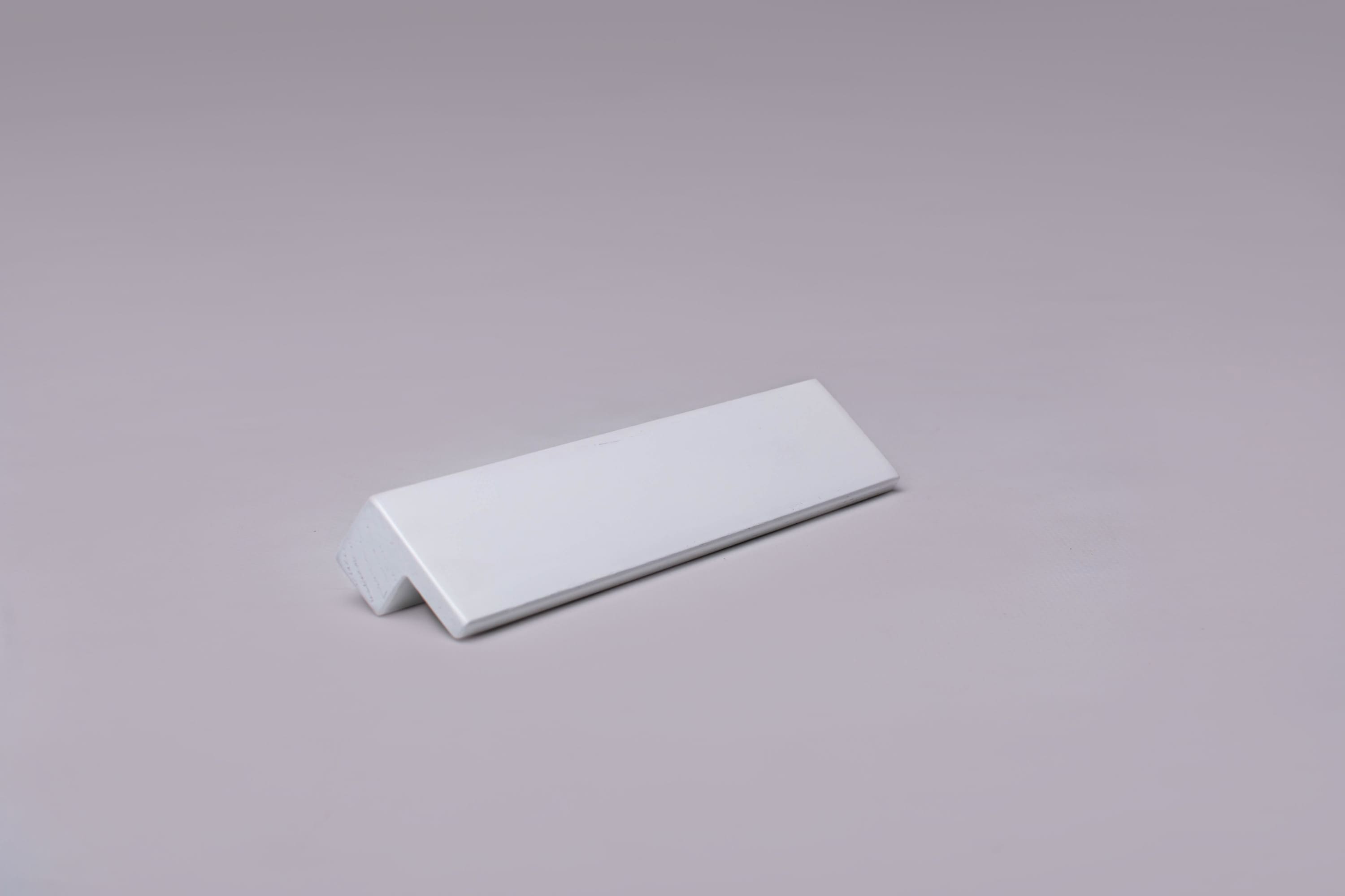 Classic L-Form White Cabinet Handle on gray