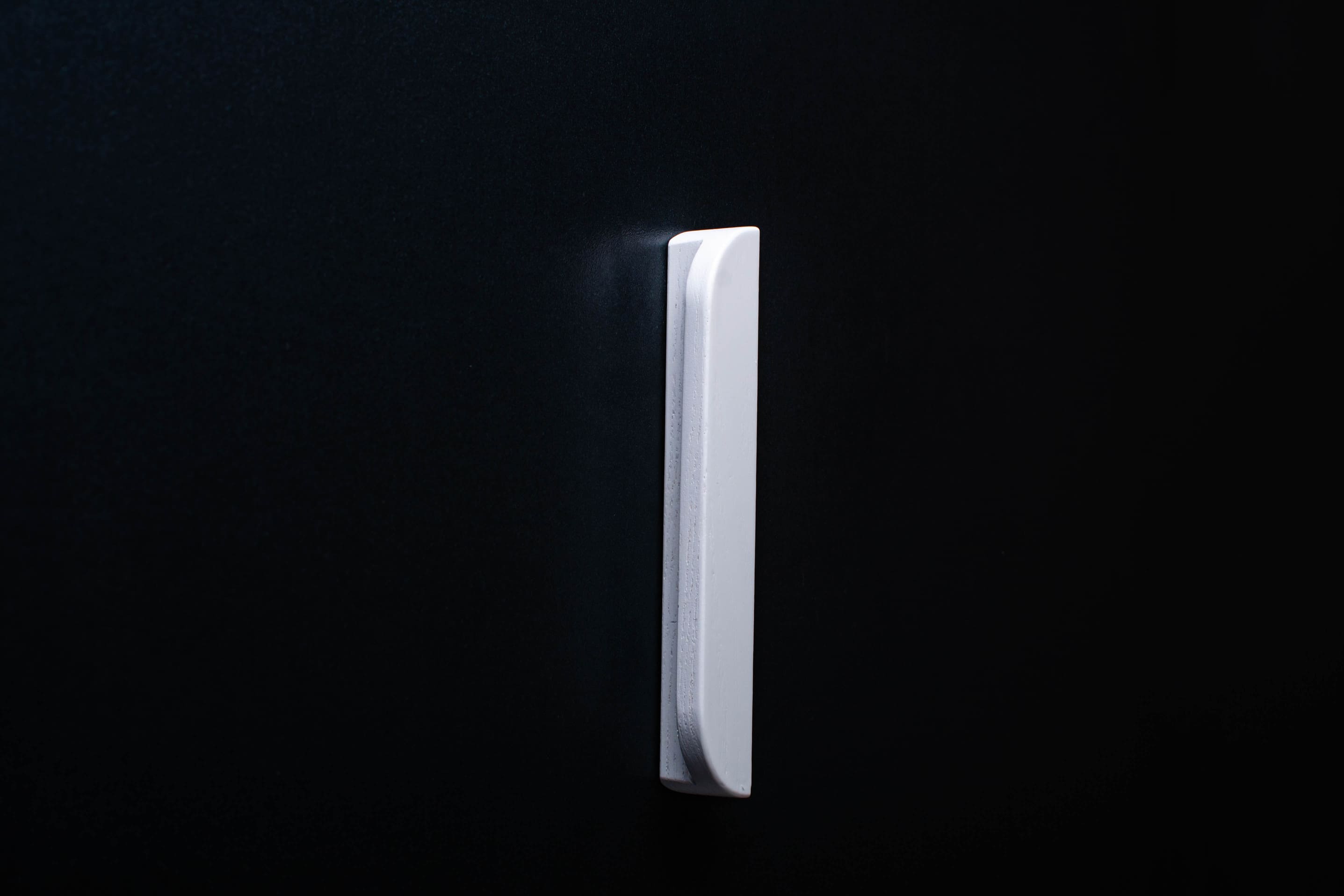 Classic Rounded White Cabinet Handle on grey