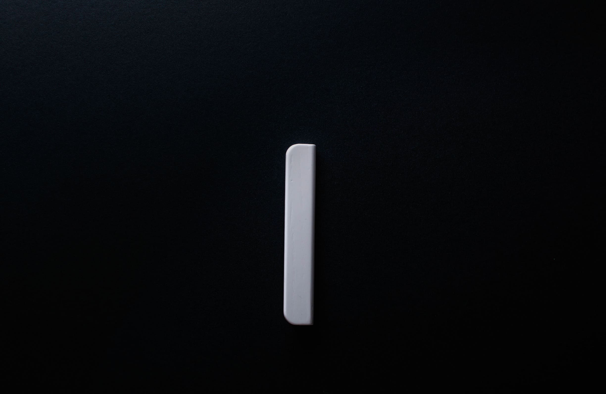 Classic Rounded White Cabinet Handle on grey