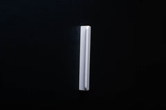 White Wooden drawer  handle in vertical position with detailed view on grip