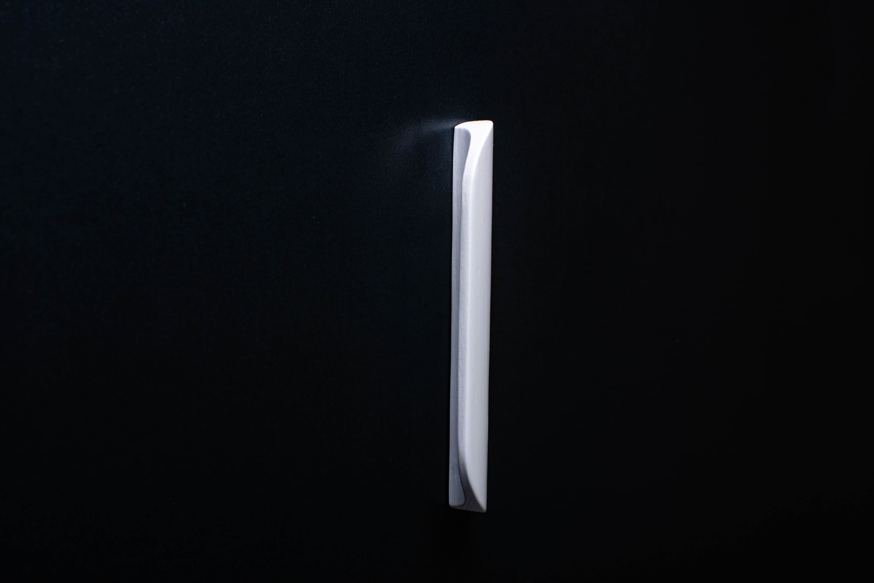 Modern Rounded White Cabinet Handle in vertical position
