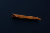Angled side perspective of a sleek European walnut handle showing its rich grain