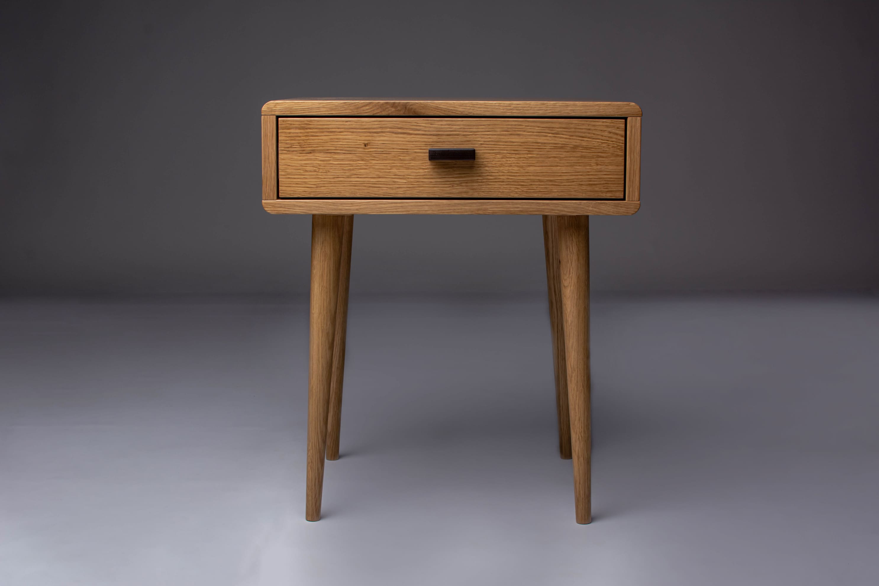 Handcrafted Mid-Century oak nightstand with a sleek design.