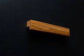 Close-up of Modern Oak Cabinet Handle on a black cabinet, showing detailed wood grain.