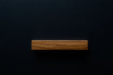 Modern Oak Handle on black cabinet drawer, showcasing the smooth finish and sturdy build.