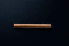 Custom-length unfinished oak handle centered on a matte black drawer