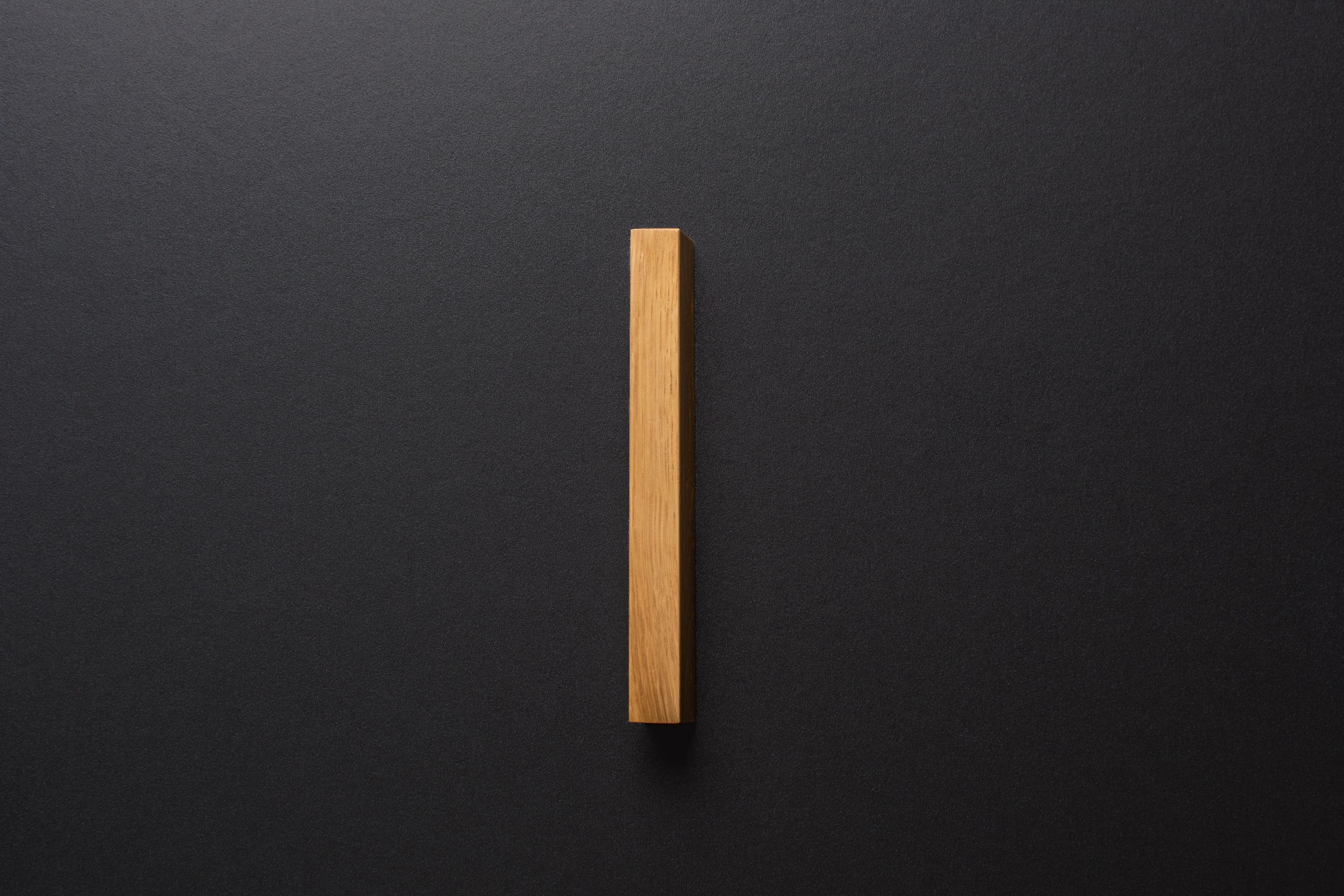 Wooden drawer oak handle in vertical position with detailed frontal view
