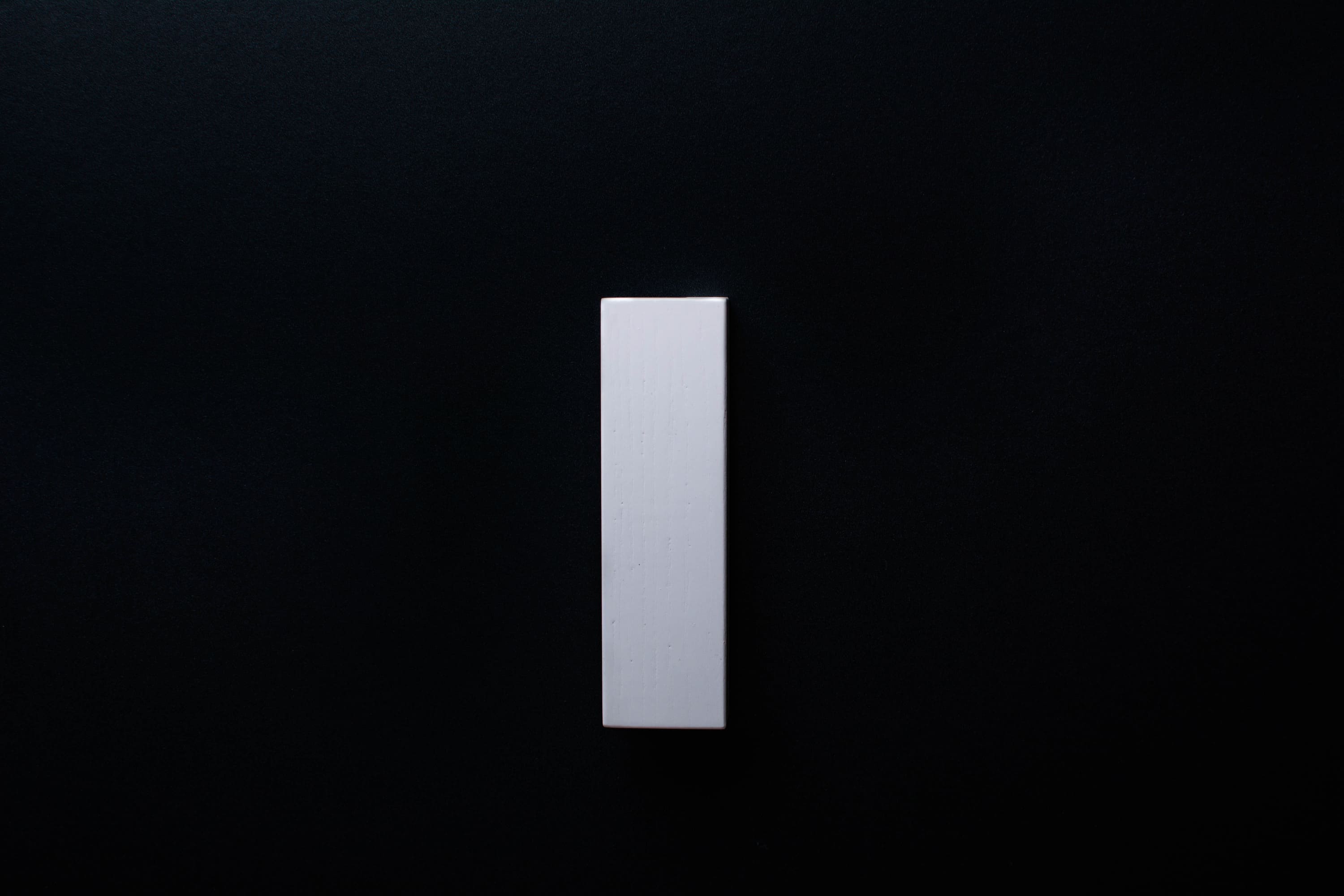 Modern white furniture handle showcasing natural wood texture