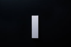 Modern white furniture handle showcasing natural wood texture