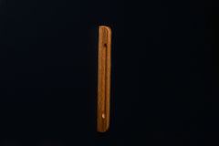 Clean lines of lacquered oak handle captured from above on a cabinet door