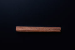 Raw American walnut cabinet handle with natural wood texture and soft brown tone