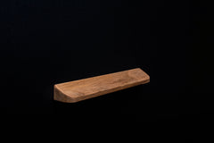 Angled photo of a raw European walnut handle showing minimalist design