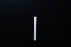 White Wooden drawer  handle in vertical position with detailed view on grip