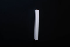 White Wooden drawer  handle in vertical position with detailed view on grip
