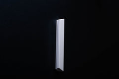 White Wooden drawer  handle in vertical position with detailed view on grip