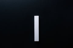 White Wooden drawer  handle in vertical position with detailed view on grip
