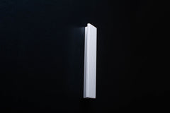 White Wooden drawer  handle in vertical position with detailed view on grip