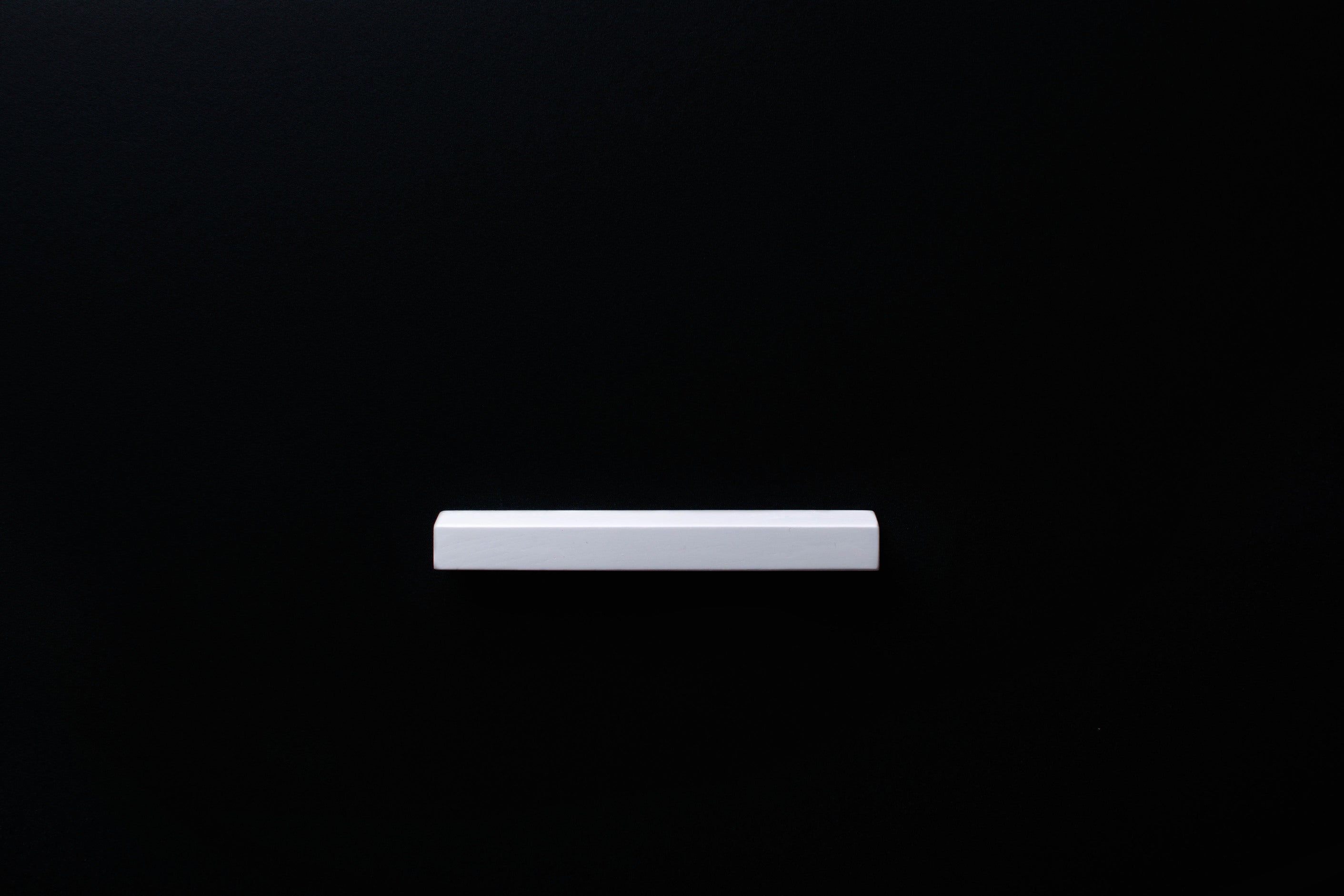 White Wooden drawer ash handle in horizontal position with detailed frontal view