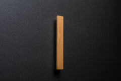 Wooden drawer ash handle in vertical position with detailed view on grip