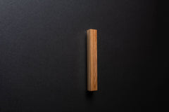 Wooden drawer ash handle in vertical position with detailed view on grip