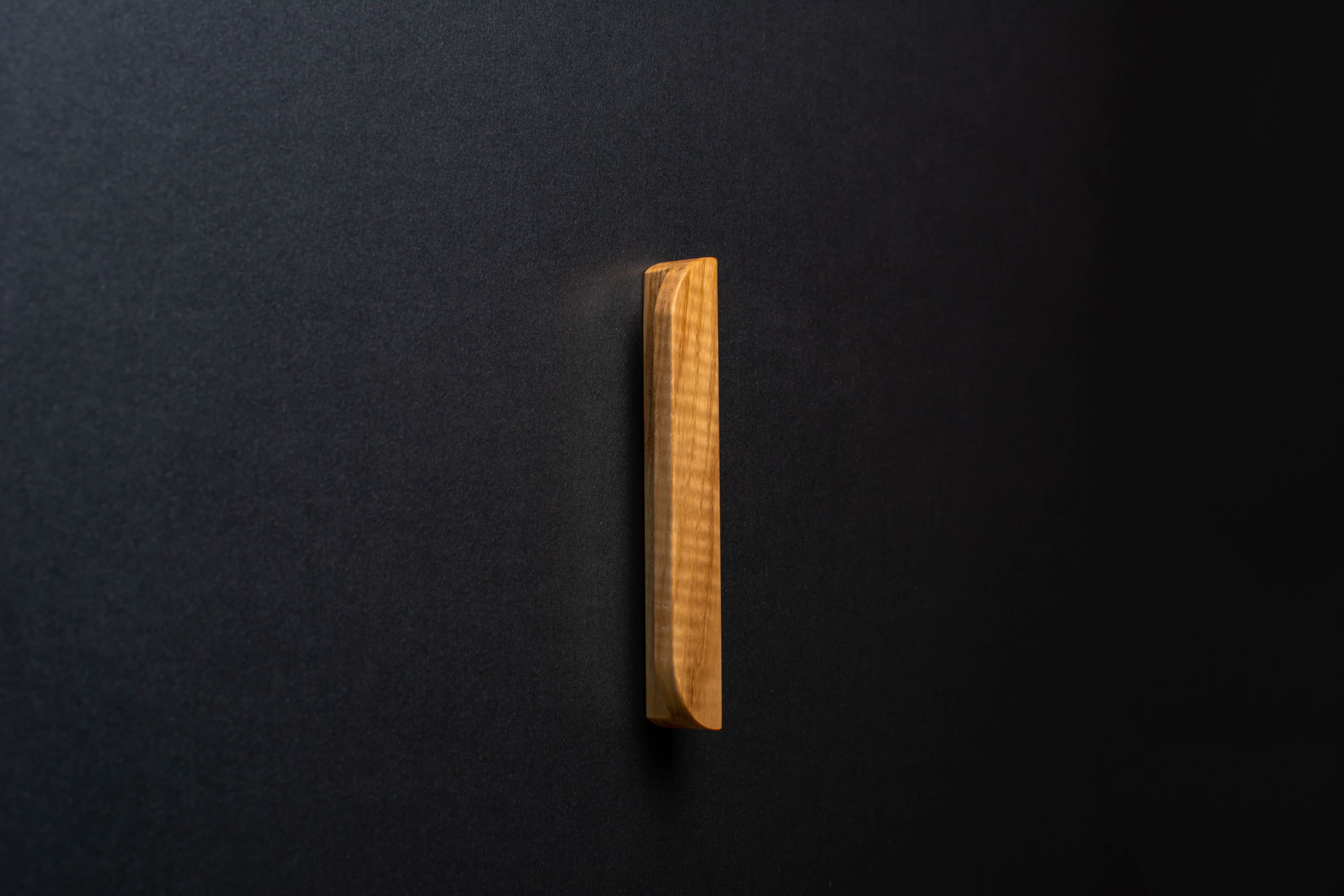 Wooden drawer modern ash handle in vertical position with detailed view on grip