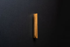 Wooden drawer modern ash handle in vertical position with detailed view on grip