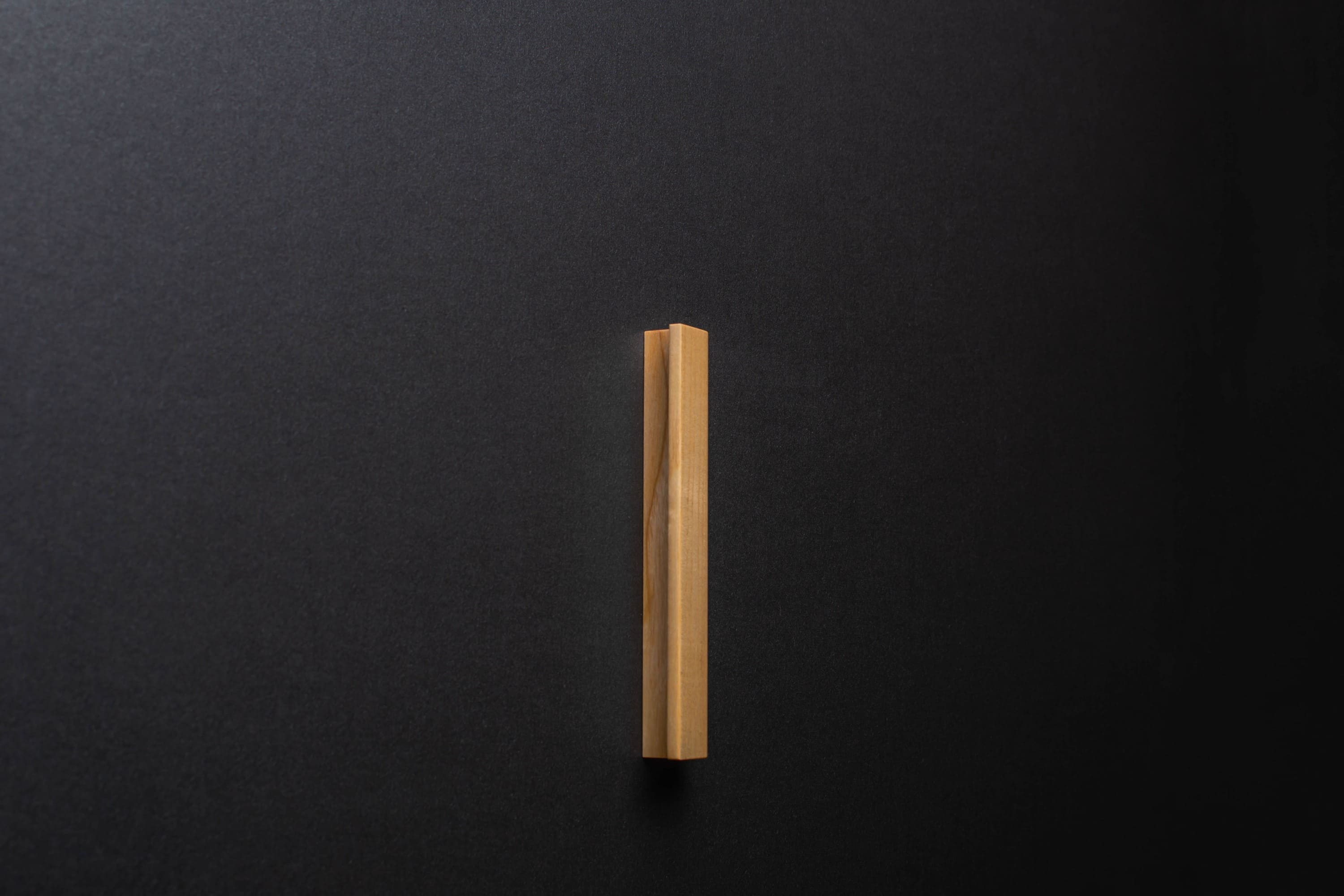 Wooden drawer modern ash handle in vertical position with detailed view on grip
