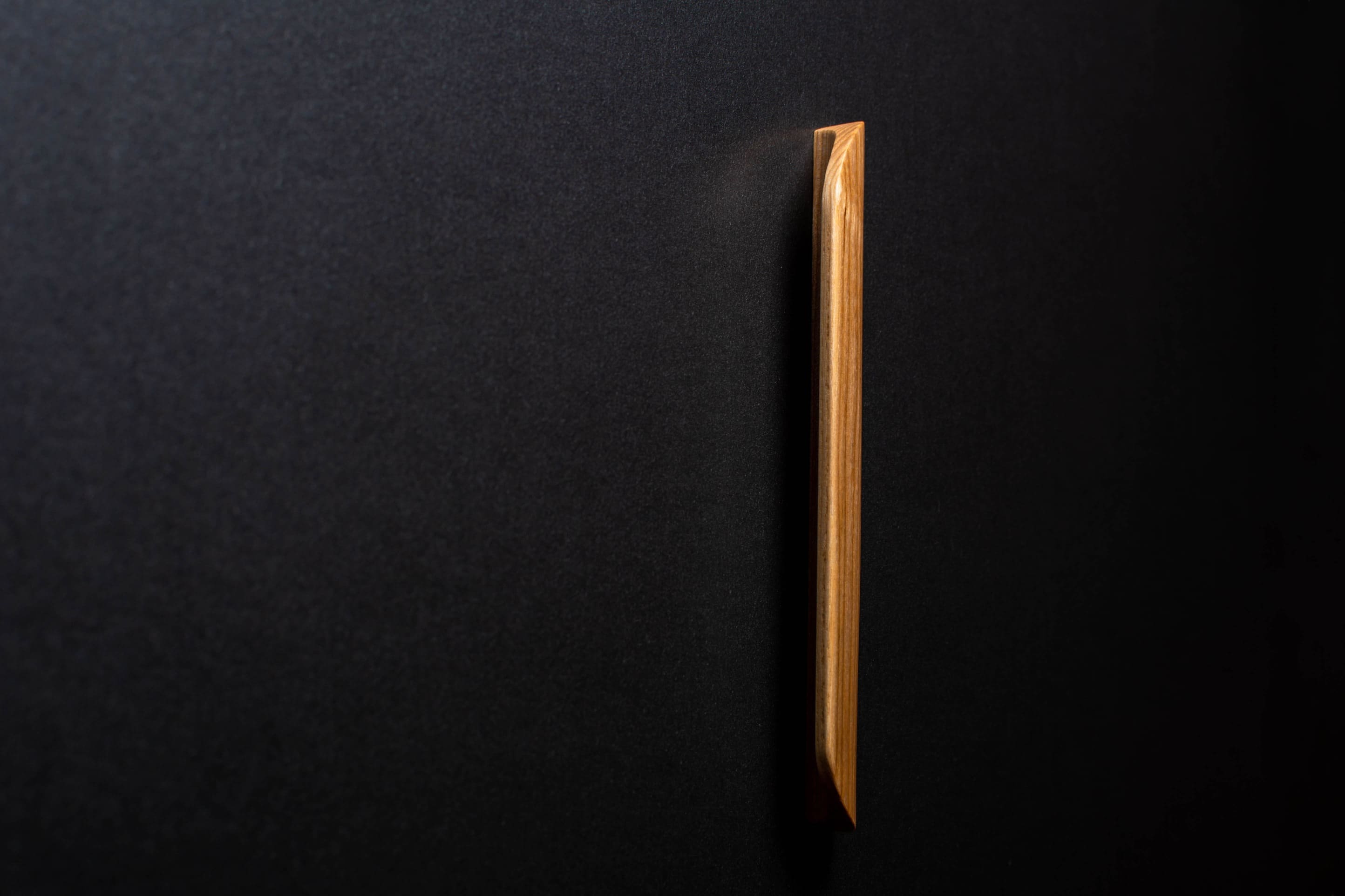 Wooden drawer ash handle in vertical position with detailed view on grip