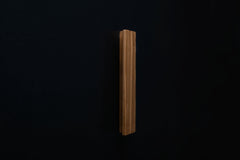 Wooden drawer ash handle in vertical position with detailed view on grip