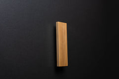 Wooden drawer ash handle in vertical position with detailed view on grip