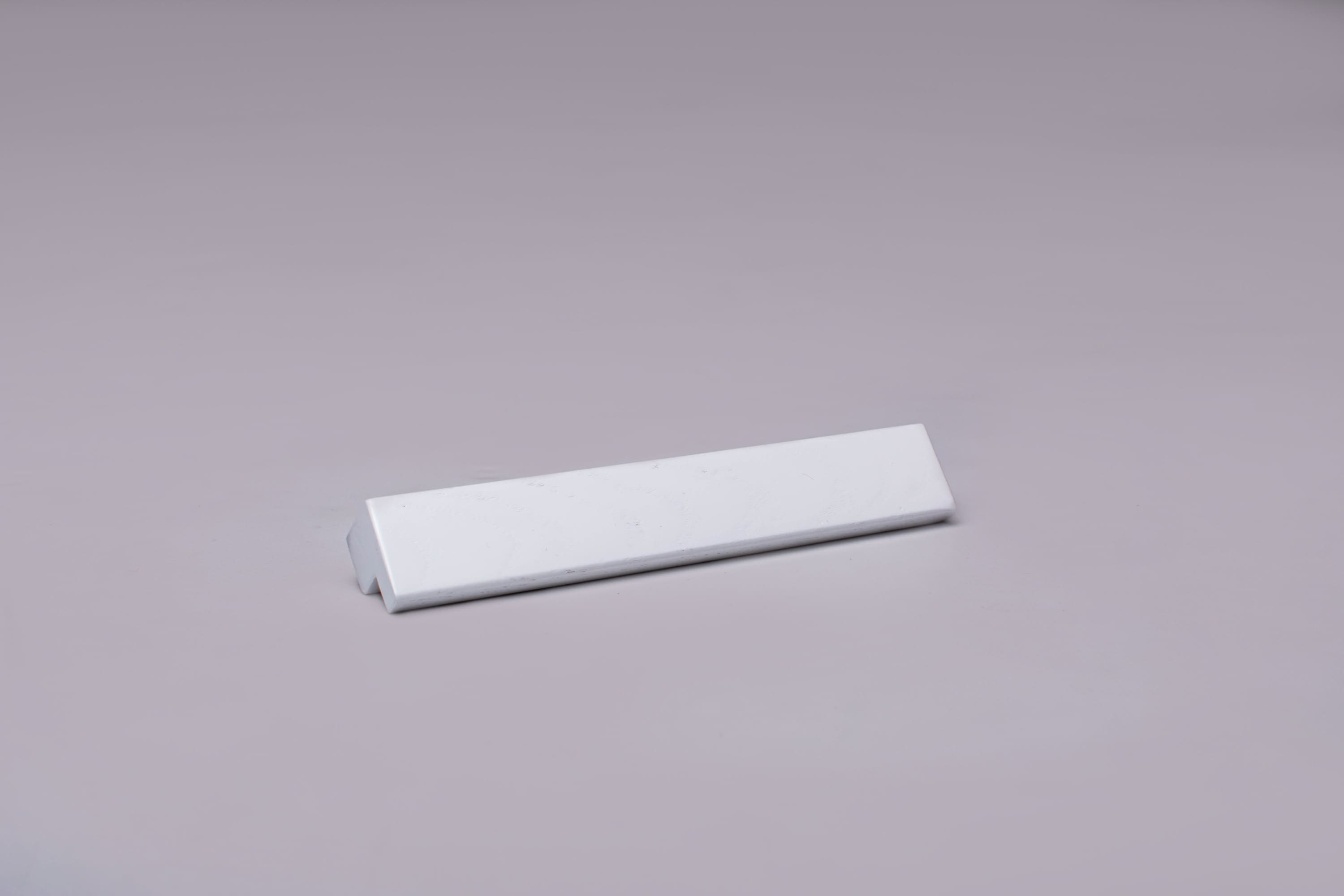 Classic L-Form White Cabinet Handle on grey 