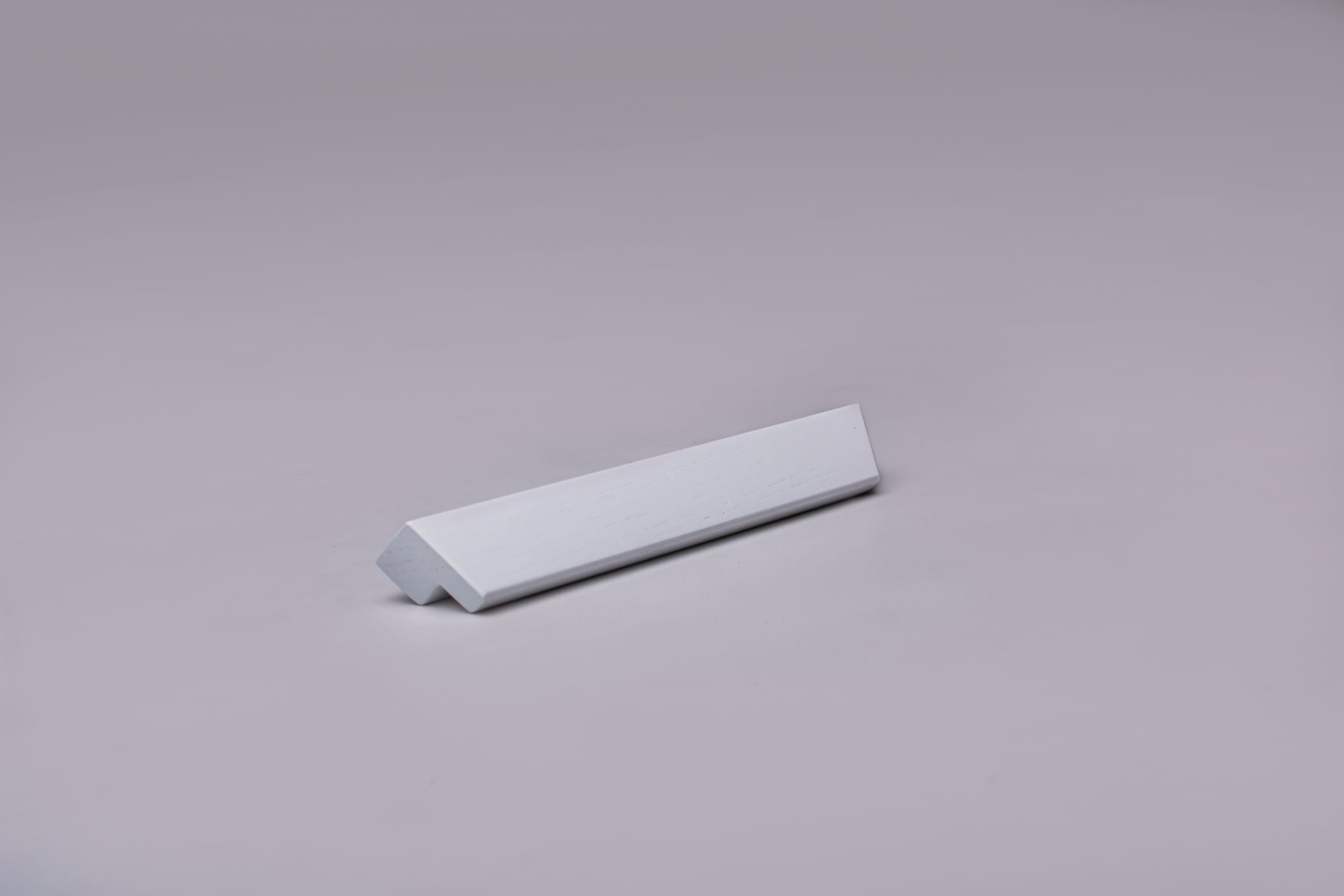 Classic L-Form White Cabinet Handle on grey 