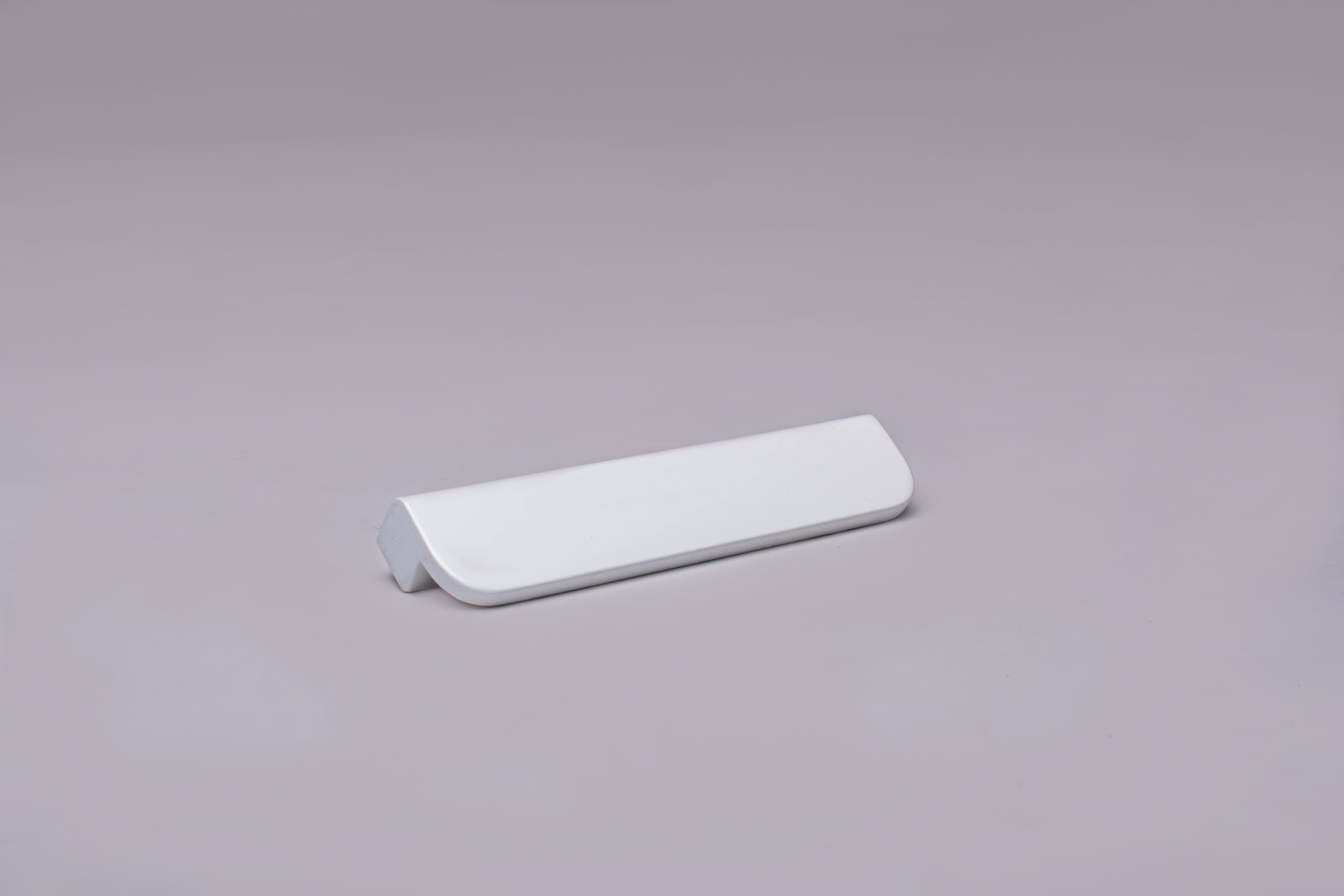 Modern L-Form White Cabinet Handle on gray 