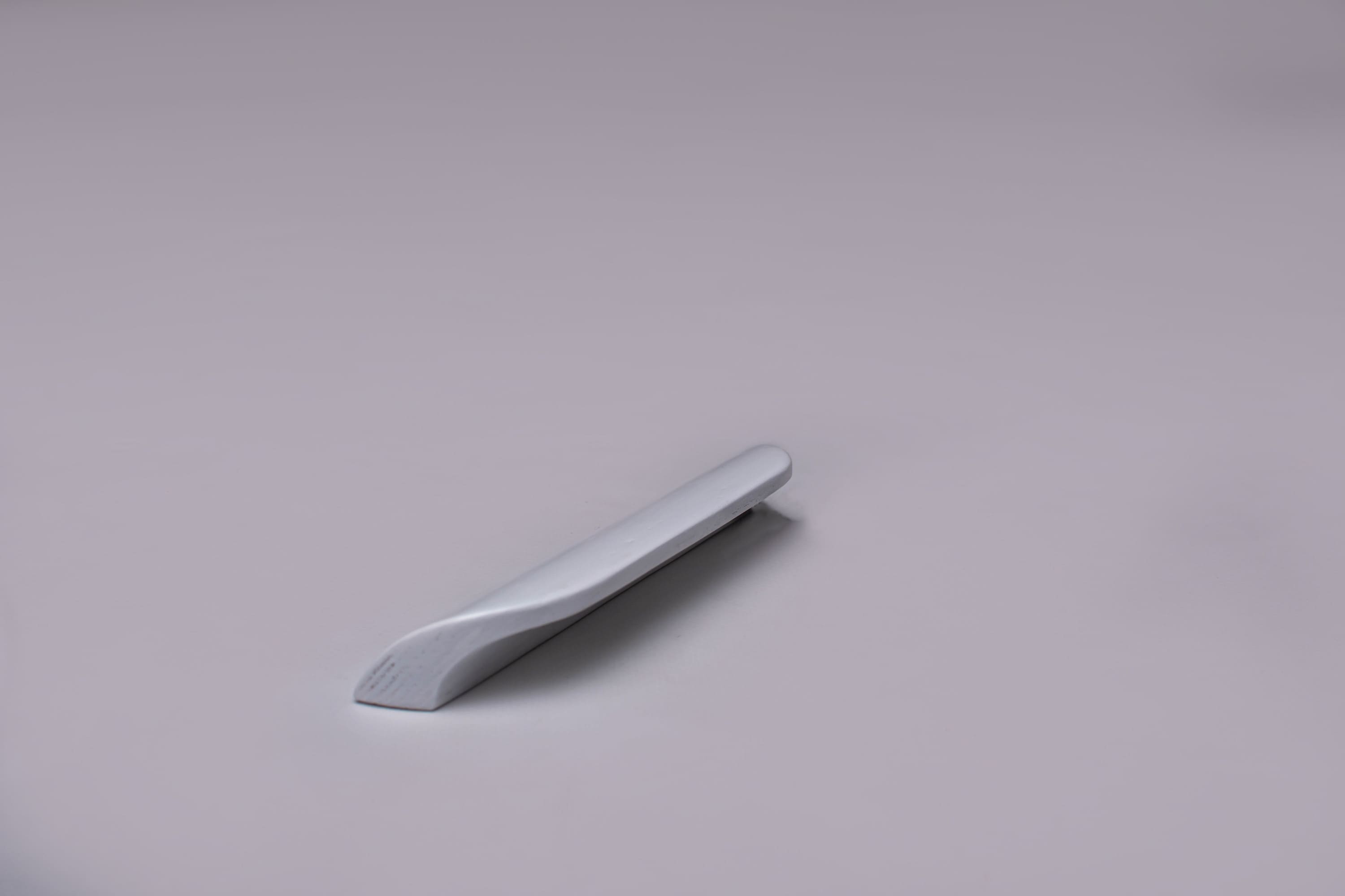 Modern Rounded White Cabinet Handle on grey 