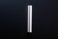 White Wooden drawer  handle in vertical position with detailed view on grip