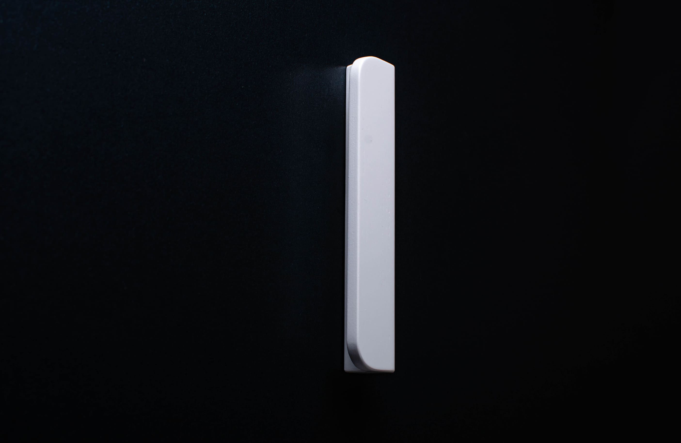 white cabinet handle with rounded edges